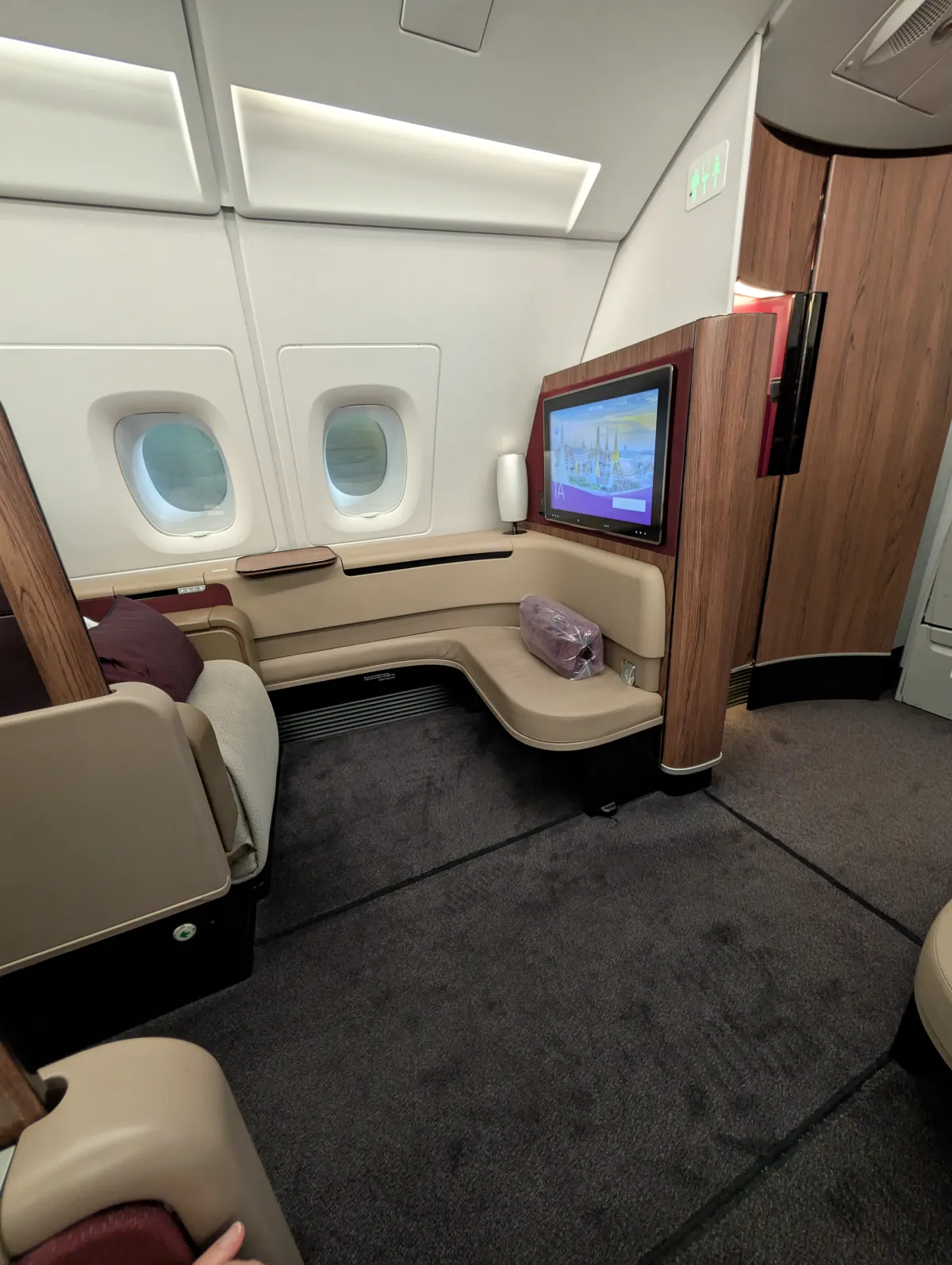 Qatar Airways First Class suite with wide window view and closet on Airbus A380