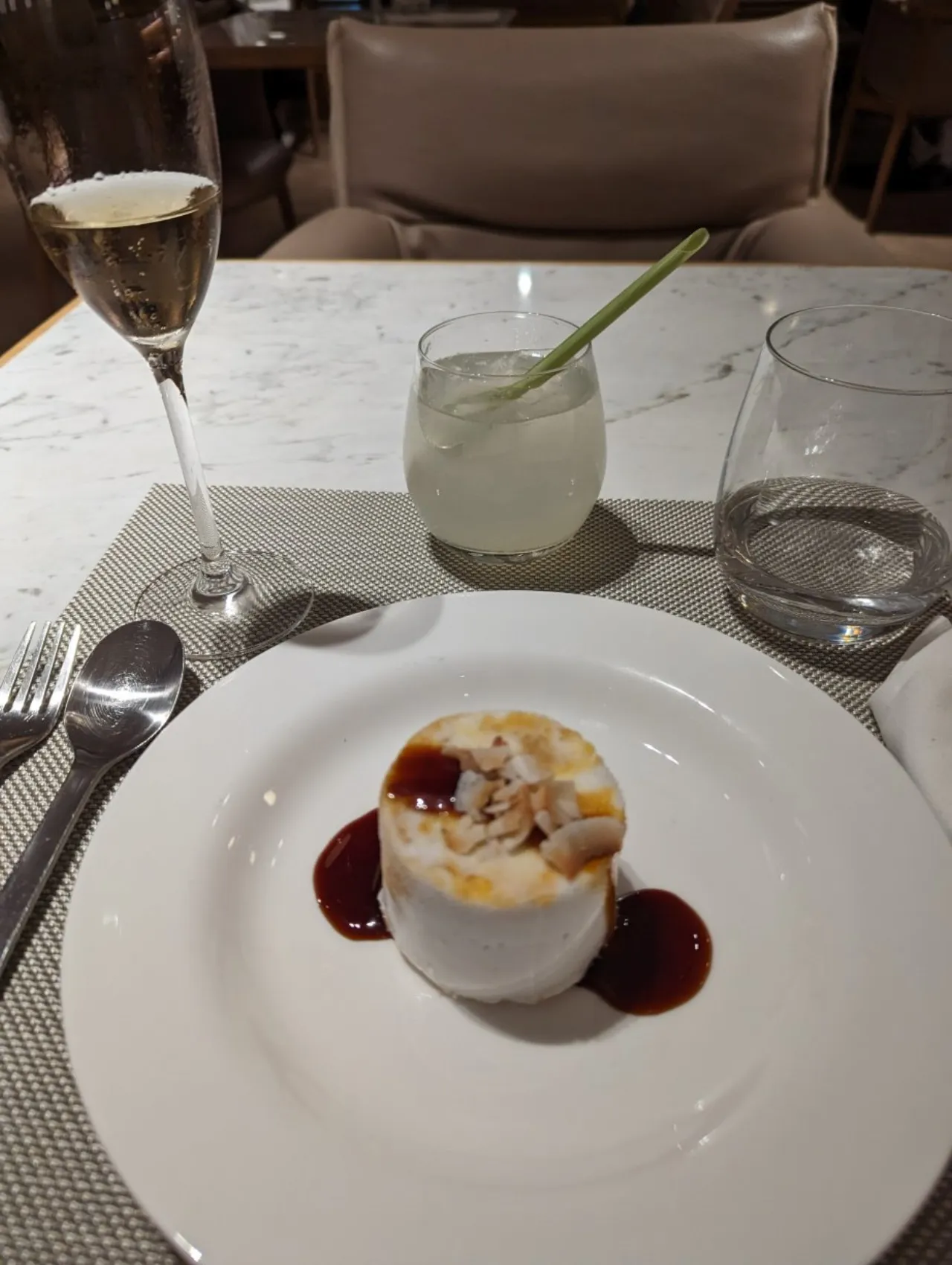 Coconut dessert served with a glass of Champagne at British Airways Concorde Dining, Changi